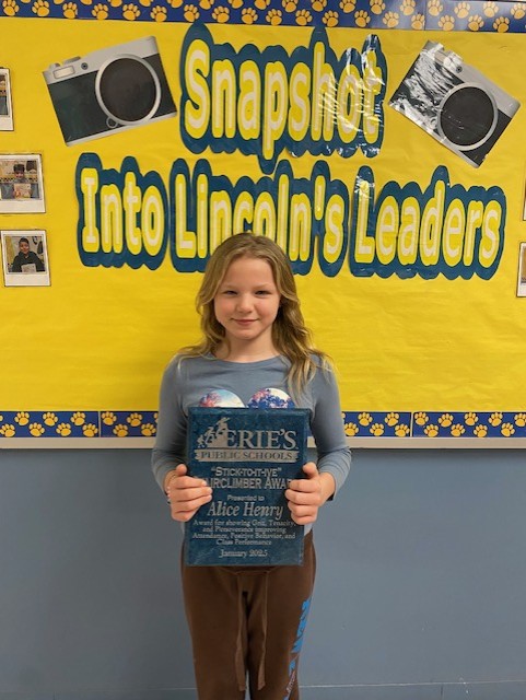 Alice Henry, Lincoln's Stairclimber recipient for the month of January, poses with her plaque.